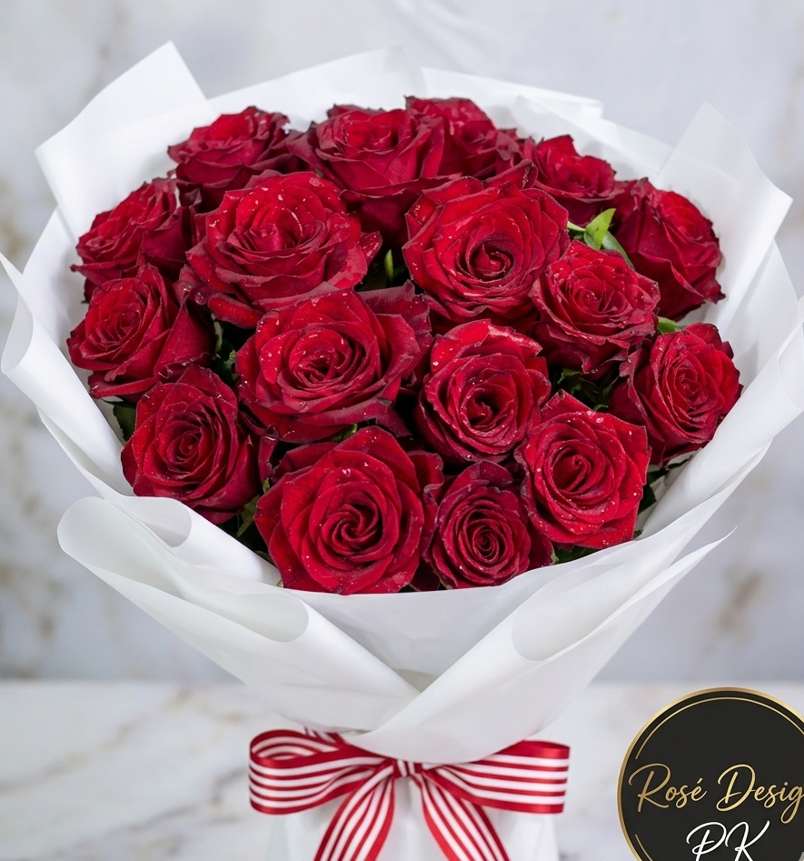 Fresh red rose bouquet wrapped in white paper for delivery in Lahore by RoseDesign.pk.